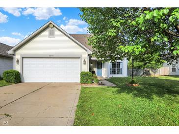 Charming single-story home with a well-maintained lawn and attached two-car garage at 5225 Thompson Park, Indianapolis, IN 46237