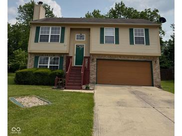 Charming two-story home featuring green shutters, a well-maintained lawn, and an attached two-car garage at 6611 Wandering Way, Indianapolis, IN 46241