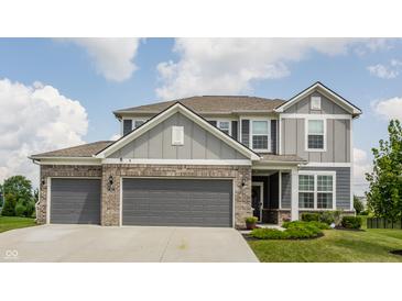 Charming two-story home featuring a two-car garage, manicured lawn, and classic architectural details at 6902 Diamondleaf Way, Brownsburg, IN 46112