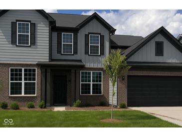 Charming two-story home featuring gray siding, dark accents, and a well-maintained lawn at 900 Cowley Dr, Westfield, IN 46074