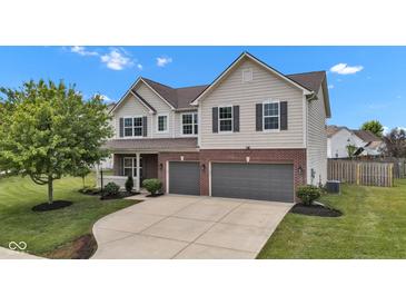 Charming two-story home with two-car garage, brick accents, and landscaped front yard at 9724 Brooks Dr, Fishers, IN 46055