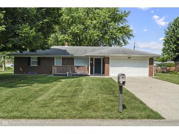 Charming single-story brick home with a well-manicured lawn and a cozy front porch at 1346 Carroll White Dr, Indianapolis, IN 46219