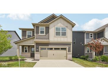 Two-story home with brown and beige siding, an attached two car garage, and covered front porch at 1911 Goodwin Pl, Westfield, IN 46074