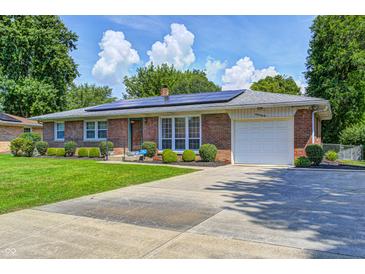 Charming brick home with solar panels, attached garage, and a well-manicured front lawn at 2020 Rosedale Dr, Indianapolis, IN 46227