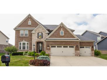 Stunning brick home featuring an attached two-car garage and professionally landscaped yard at 2783 W High Grove Cir, Zionsville, IN 46077