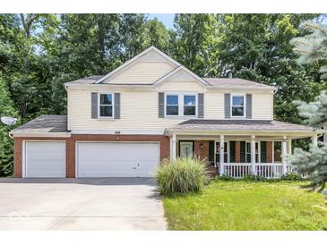 Inviting two-story home with a two car garage, classic shutters, and a charming front porch at 4223 Kestrel Ct, Indianapolis, IN 46254