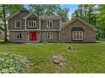 Attractive two-story home featuring a red front door, brick accents, and a well-maintained lawn at 429 Glenbrook Ln, Avon, IN 46123