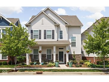 Charming two-story home with a welcoming front porch and beautifully landscaped front yard at 5832 Buskirk Dr, Indianapolis, IN 46216