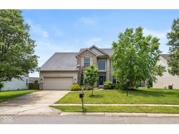 Charming two-story home with a well-manicured lawn and attached two car garage at 8336 Bent Oak Dr, Indianapolis, IN 46236