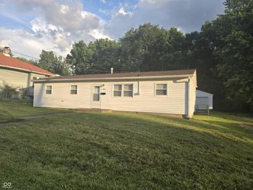 Charming single-story home with a well-maintained lawn and detached garage provides comfortable and convenient living at 1201 E Gimber St, Indianapolis, IN 46203