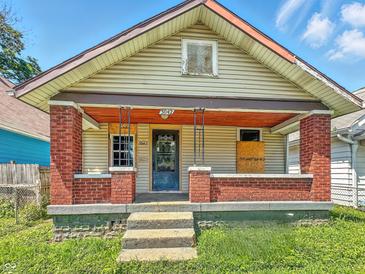 This property features a small front porch with brick columns at 3042 Newton Ave, Indianapolis, IN 46201