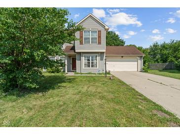 Charming two-story home featuring a well-maintained lawn, attached garage, and classic siding at 4533 Golden Meadow Dr, Indianapolis, IN 46254