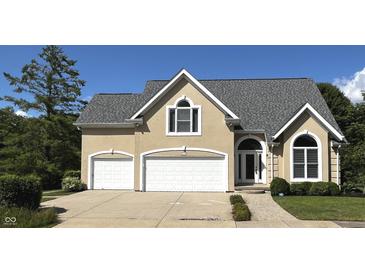 Charming home with a two-car garage and landscaped front yard, offering great curb appeal at 4770 Winterberry Pl, Columbus, IN 47201