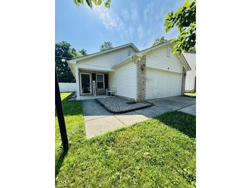 Charming single-Gathering home featuring a well-manicured lawn and a two-car garage at 8323 Lake Tree Ln, Indianapolis, IN 46217