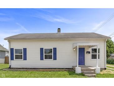 Charming single-story home featuring white siding and a blue front door at 920 State St, Shelbyville, IN 46176