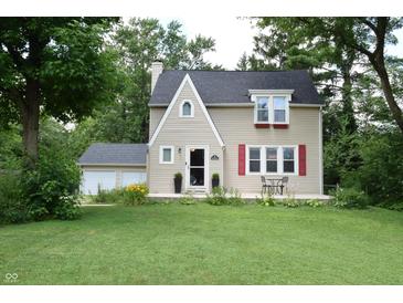 Inviting two-story home with red shutters, front patio and well maintained lawn at 115 Northshore Blvd, Anderson, IN 46011