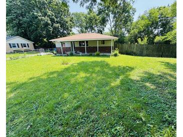 A single story home featuring a spacious front yard with green grass at 1345 S Biltmore Ave, Indianapolis, IN 46241