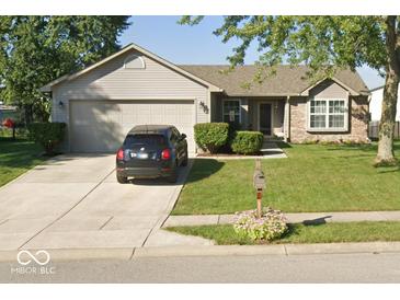 Charming home featuring a two-car garage, well-maintained lawn, and a mix of siding and brick accents at 18 Meadow Creek E Blvd, Whiteland, IN 46184