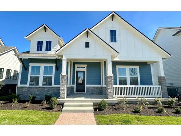 Charming two-story home featuring blue siding, white trim, stone accents, and a welcoming front porch at 19995 Gansett Rd, Westfield, IN 46074