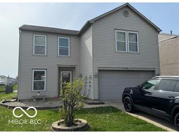 Two-story home featuring a large garage, trimmed windows, and a manicured lawn at 2230 Cedarmill Dr, Franklin, IN 46131