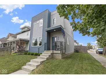 Modern two-story home with blue and gray siding, concrete stairs, and a well-manicured lawn at 2326 Prospect St, Indianapolis, IN 46203