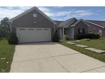 Charming single Gathering home with attached two car garage and a concrete driveway at 2929 Tuscarora Ln, Indianapolis, IN 46217