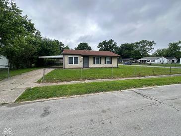 Charming single-story home with a chain-link fence and a convenient carport at 3302 N Butler Ave, Indianapolis, IN 46218