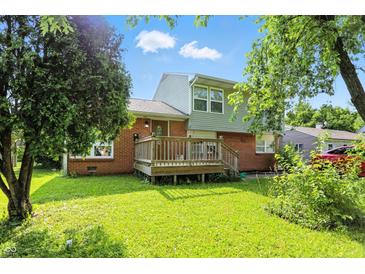 Charming home featuring a brick facade, front deck, and a well-maintained lawn at 4023 N Arlington Ave, Indianapolis, IN 46226