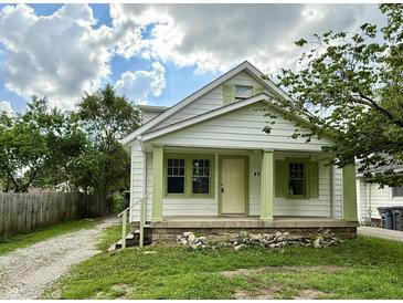Charming home featuring green trim, covered porch, and beautifully maintained front lawn at 492 S Livingston Ave, Indianapolis, IN 46241
