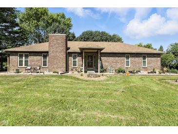 Charming brick home featuring a well-manicured lawn and inviting front entrance at 1346 N Buck Creek Rd, Greenfield, IN 46140