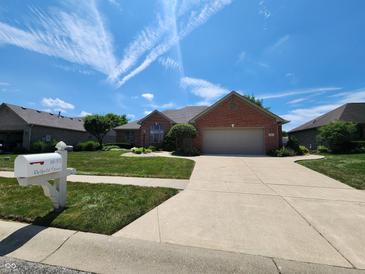 Charming brick home with a well-manicured lawn and a two-car garage at 1633 Belfield St, Indianapolis, IN 46217