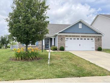Charming single-story home featuring a two-car garage, well-manicured lawn and beautiful landscaping at 1706 Creekwater Pass, Greenfield, IN 46140