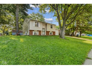 Charming split-level home with well-maintained lawn and mature trees at 1809 Mutz Dr, Indianapolis, IN 46229