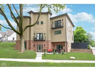 Modern three-story home with balconies, brick accents, and a well-maintained lawn at 2130 Brookside Pkwy N Dr, Indianapolis, IN 46201