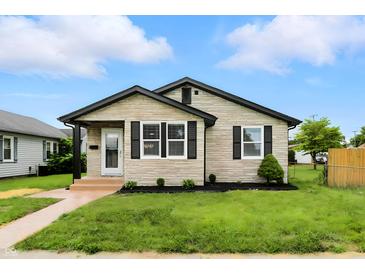 Charming single-story home boasting a stone facade, black trim, and well-manicured lawn at 2715 S A St, Elwood, IN 46036