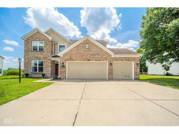 Charming brick home featuring a three-car garage, well-maintained lawn, and inviting curb appeal at 296 Myers Lake Dr, Noblesville, IN 46062