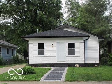 Charming renovated bungalow with white siding, contrasting trim and a well-manicured lawn at 3455 Brouse Ave, Indianapolis, IN 46218