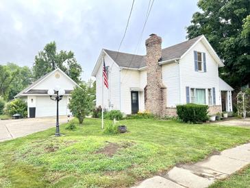 Charming two-story home with a detached garage and a well-manicured front yard with mature trees at 4096 N 200 W, Greenfield, IN 46140