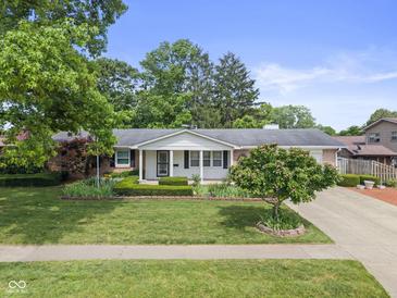 Charming brick ranch home featuring a manicured lawn and well-maintained landscaping at 649 Lawndale Dr, Plainfield, IN 46168