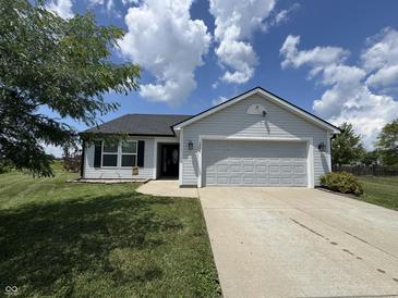 Charming single-story home with a well-manicured lawn and attached two-car garage at 1406 Bigleaf Cir, Sheridan, IN 46069