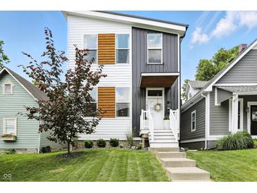 Striking two-story home boasting a modern facade, manicured lawn, and inviting front steps at 1406 Linden St, Indianapolis, IN 46203