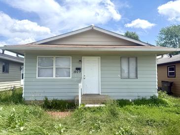 Charming single-story home featuring a well-maintained exterior, front door, and landscaped front yard at 1509 S Rural St, Indianapolis, IN 46203