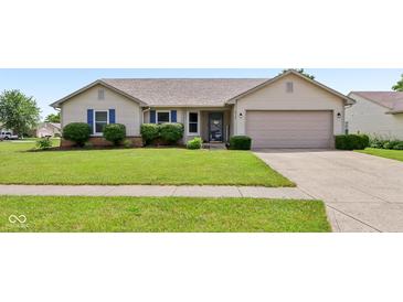 Charming single-story home featuring blue shutters, well-manicured lawn, and an attached two car garage at 2127 Yosemite Dr, Lebanon, IN 46052