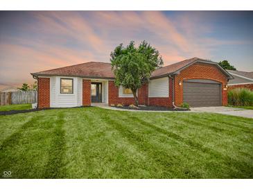Charming home with a brick and siding exterior, well-manicured lawn, and attached garage, offering great curb appeal at 248 Eastview Dr, Bargersville, IN 46106