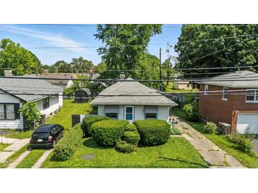 Charming one-story home featuring well-maintained landscaping and a quaint, inviting facade at 4708 Fletcher Ave, Indianapolis, IN 46203