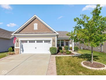 Charming single-story home with a well-manicured lawn and a two-car garage on a beautiful, sunny day at 4905 Lilium Dr, Plainfield, IN 46168