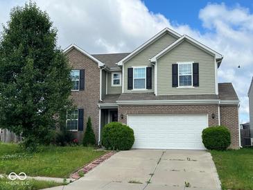 Two-story home with attached two car garage, brick and vinyl siding, and well manicured lawn at 7532 Gold Rush Ct, Camby, IN 46113