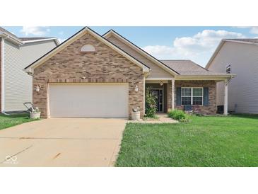 Charming single-story brick home featuring an attached garage and well-maintained front lawn at 958 Denton Ct, Westfield, IN 46074