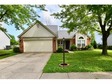 Charming single-story home features a two-car garage, brick accents, and a well-manicured front yard at 10548 Magenta Dr, Noblesville, IN 46060