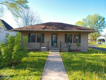 Charming single-story home with a well-maintained lawn and inviting front porch at 1155 E Perry St, Indianapolis, IN 46227